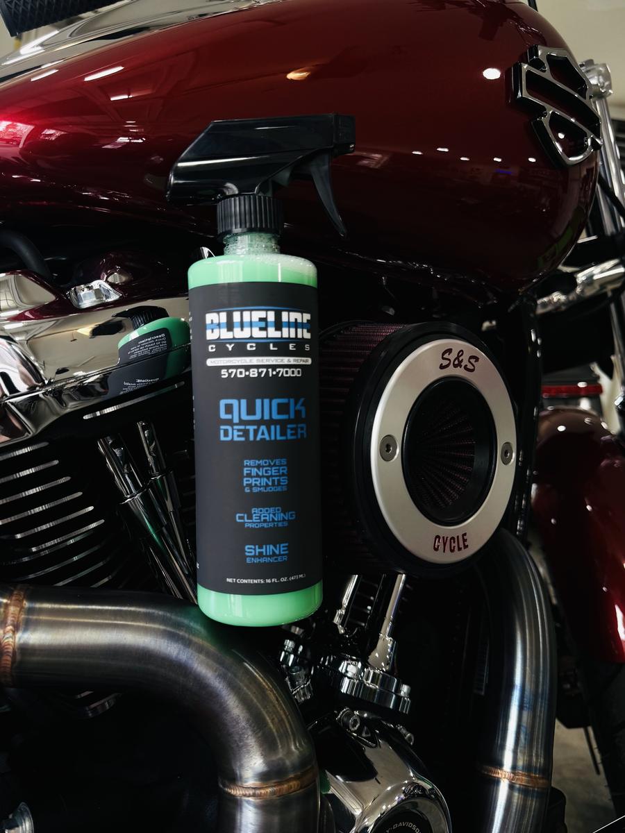 BlueLine Cycles Quick Detailer bottle resting on a customer's Harley next to an S&S air cleaner